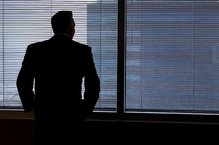 Businessman window looking out window photo