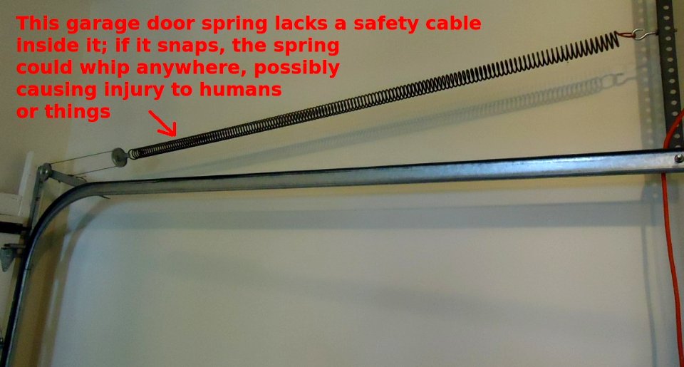 Garage door spring needs a safety cable through it