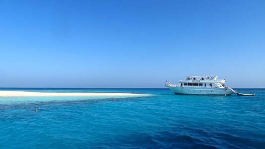 Sandy beach blue boat photo