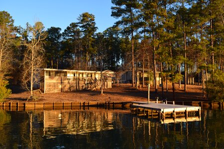 Boat dock pine trees reflection
