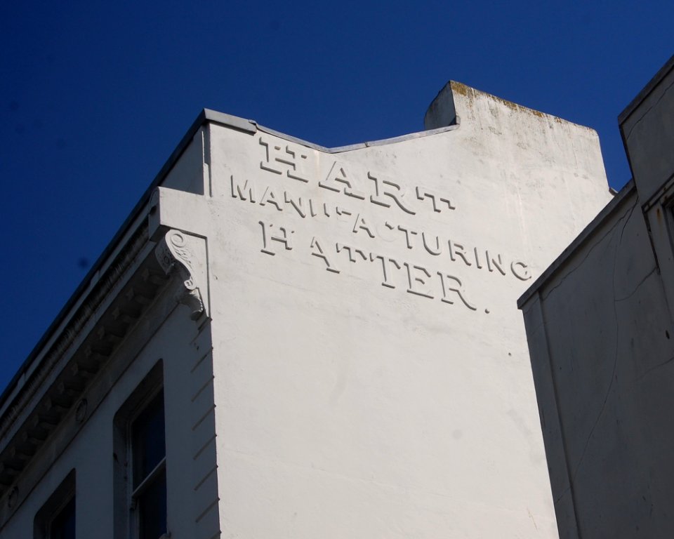 Ghost Sign for Hart Manufacturing Hatter, 51–52 North Street, Brighton (May 2020)