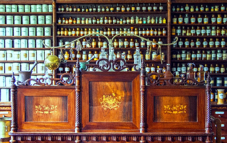 Historical pharmacy counter wooden desk glass bottles