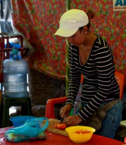 Girl preparing food in the vicinity of the Basilica of Chiquinquira