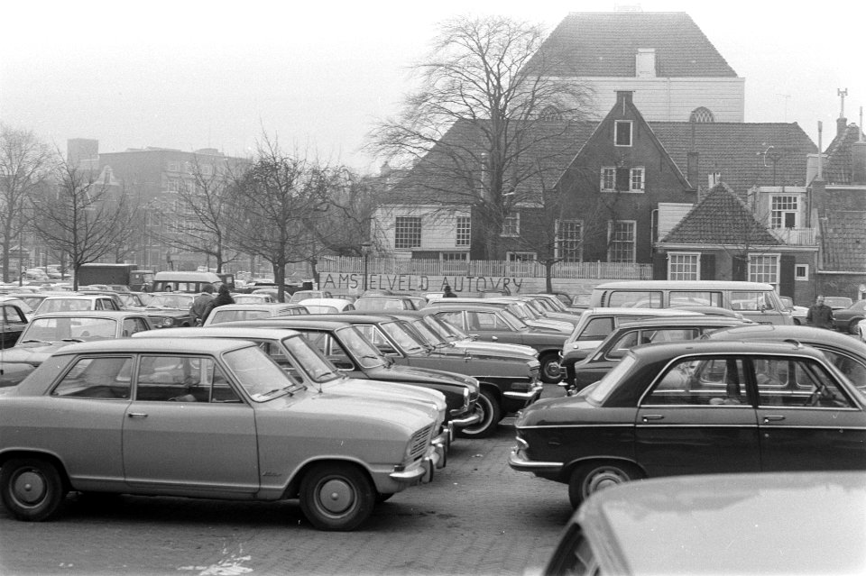 Geparkeerde autos op Amstelveld, met op achtergrondd tekst op muur Amstelveld O, Bestanddeelnr 925-4458
