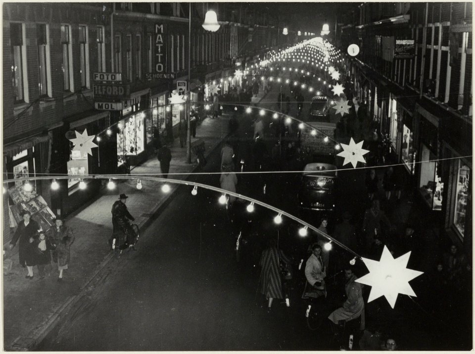 Gen. Cronjéstraat bij avond met feestverlichting. NL-HlmNHA 54004350
