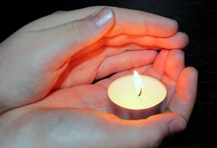 Children's hands protect flame