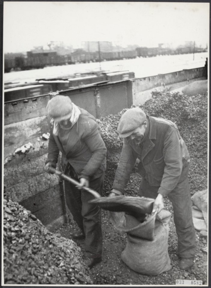 Geen bijschrift Arbeiders scheppen kolen in jute zakken in een open goederenw, Bestanddeelnr 033-0582