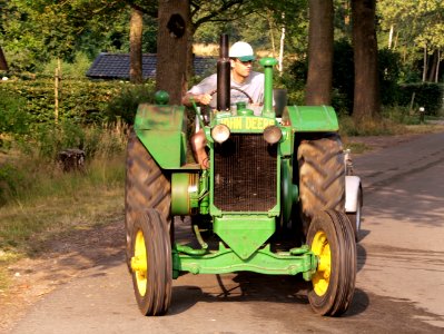 Green John Deere tracktor on the road pic1