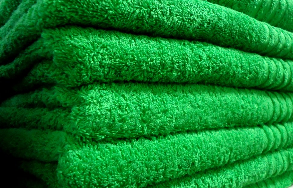 Green towels on a shelf in a store in New Jersey
