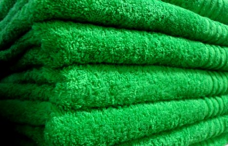 Green towels on a shelf in a store in New Jersey