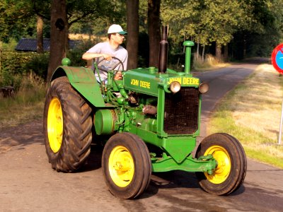 Green John Deere tracktor on the road pic2
