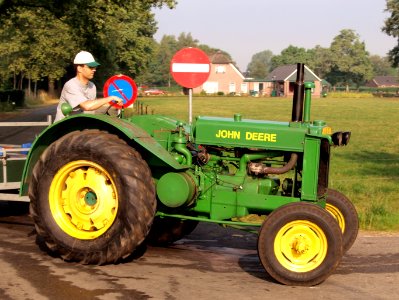 Green John Deere tracktor on the road pic3