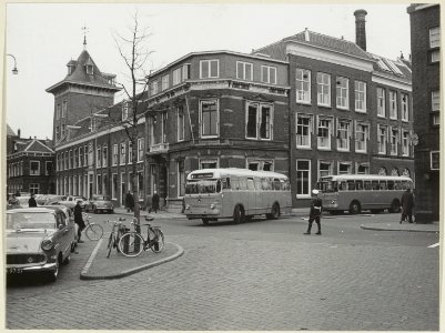 Grafische inrichting Joh. Enschedé en Zn. aan het Klokhuisplein hoek Damstraat, met NZH bussen en verkeersagent. NL-HlmNHA 54004420