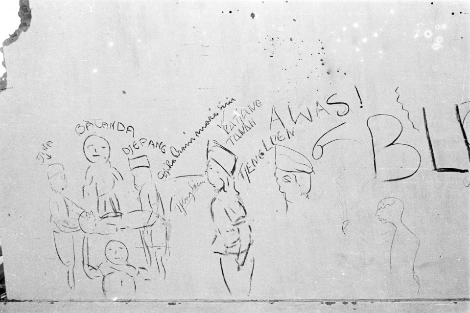 Grafitti. Tekening van figuren rond een figuur die staat op een figuur die weer , Bestanddeelnr 332-5-3