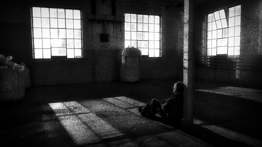 Black white window man lying on the ground photo