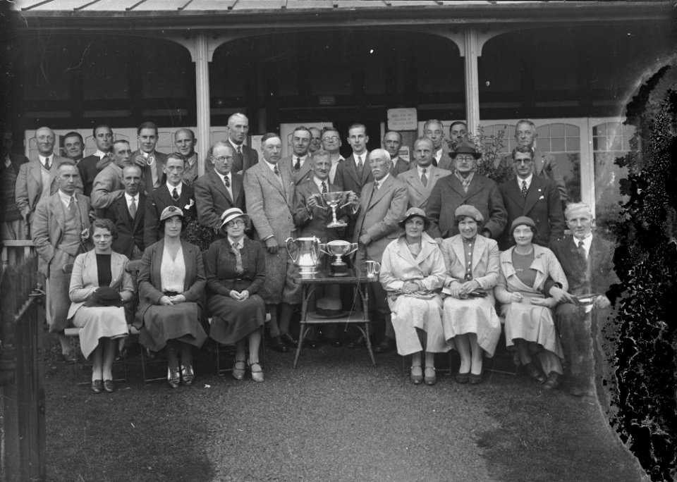 Group of golfers outside Llandrindod Wells Golf Club pavilion with trophies (1293864)