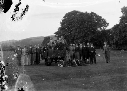 Group of men on a golf course with green keeping equipment (1294616)
