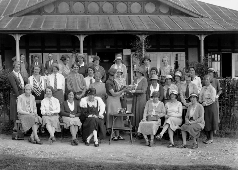 Group outside Llandrindod Wells Golf Club pavilion, with a lady golfer being presented with a cup (1295045)