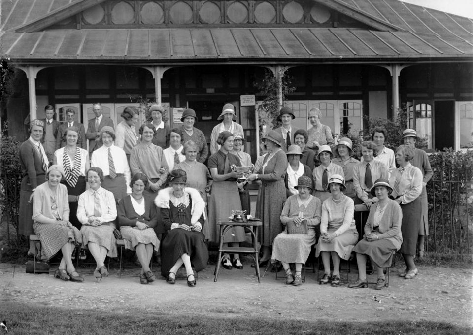 Group outside Llandrindod Wells Golf Club pavilion, with a lady golfer being presented with a cup (1294859)