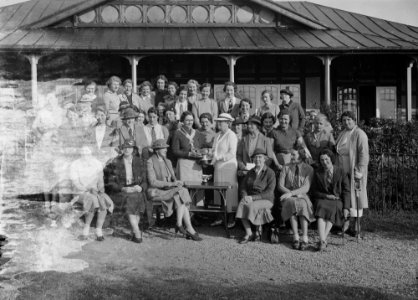 Group outside Llandrindod Wells Golf Club pavilion, with a lady golfer being presented with a cup (1294927)