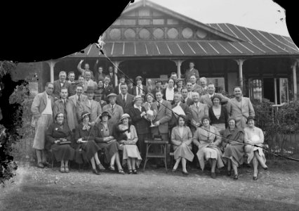 Group of golfers outside Llandrindod Wells Golf Club pavilion, one being presented with a cup (1295008)