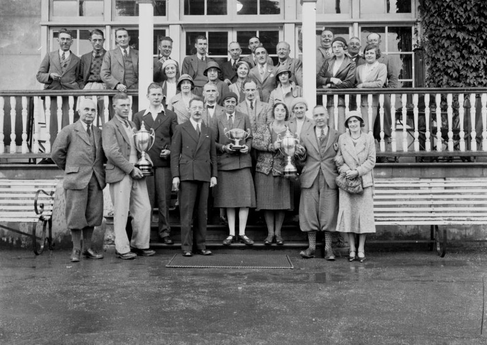 Group of golfers outside Llandrindod Wells Golf Club pavilion with trophies (1293530)