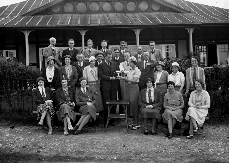 Group outside Llandrindod Wells Golf Club pavilion, with a lady golfer being presented with a cup (1294661)