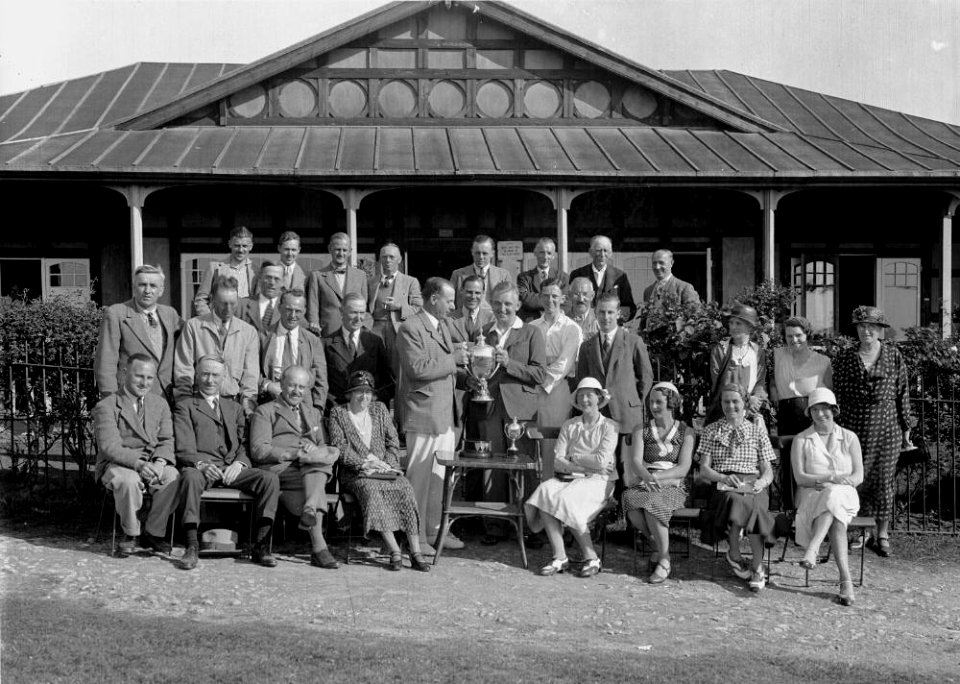 Group outside Llandrindod Wells Golf Club pavilion, with a gentleman golfer being presented with a cup (1293890)