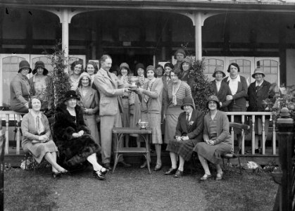 Group of women golfers outside Llandrindod Wells Golf Club pavilion, one being presented with the Open Challenge Bowl (1293980)