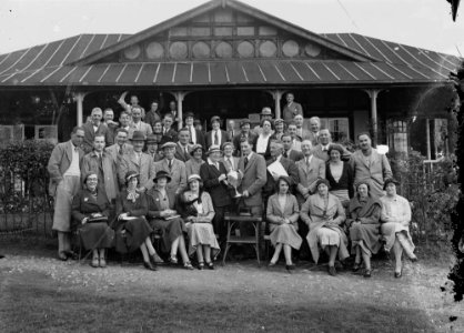 Group outside Llandrindod Wells Golf Club pavilion, with a gentleman golfer being presented with a cup (1295138)