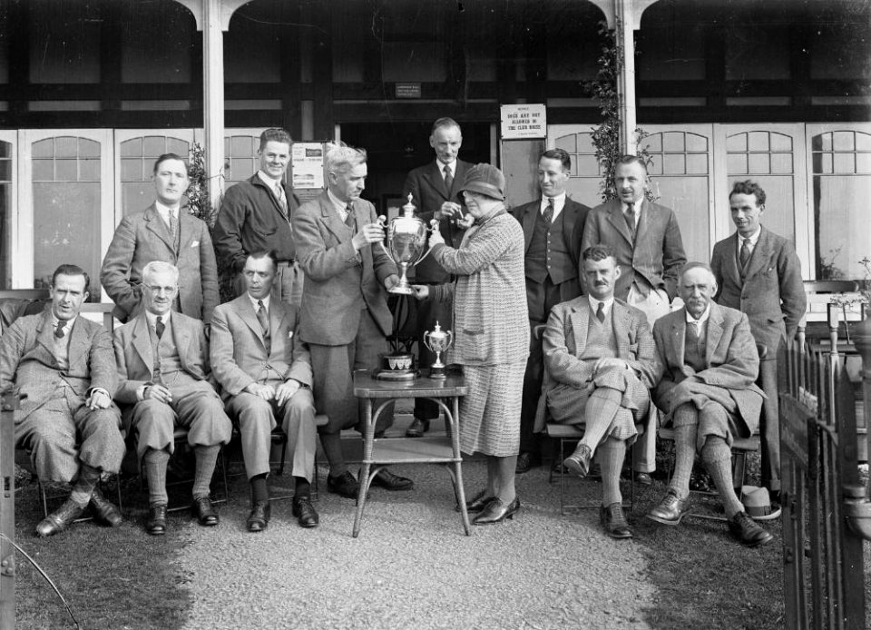Group outside Llandrindod Wells Golf Club pavilion, with a lady golfer being presented with a cup (1293392)