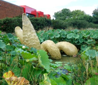 Grounds for Sculpture figure in a pond with large-leaf plants