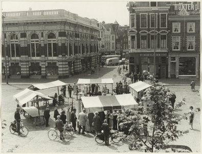 Grote Markt, zuidzijde en ziende naar het zuiden, hoek Grote Houtstraat, tijdens een kunstmarkt. NL-HlmNHA 54016037