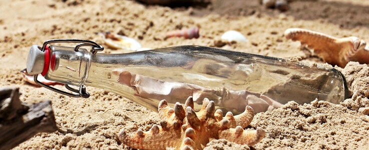 Beach sand glass bottle photo
