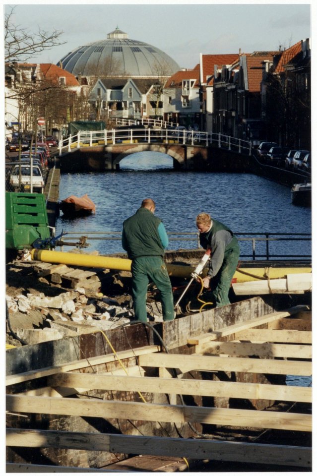 Het openbreken van de Antoniebrug over de Burgwal, ziende naar de koepelgevangenis. NL-HlmNHA 54036396