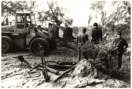 Het rooien van bomen voor de uitbreiding van de begraafplaats bij de NEd. Herv. kerk te Bennebroek tussen de Binnenweg en de Bennebroekerlaan (op de achtergrond). Oriëntatie Ziende naar het, NL-HlmNHA 54016685