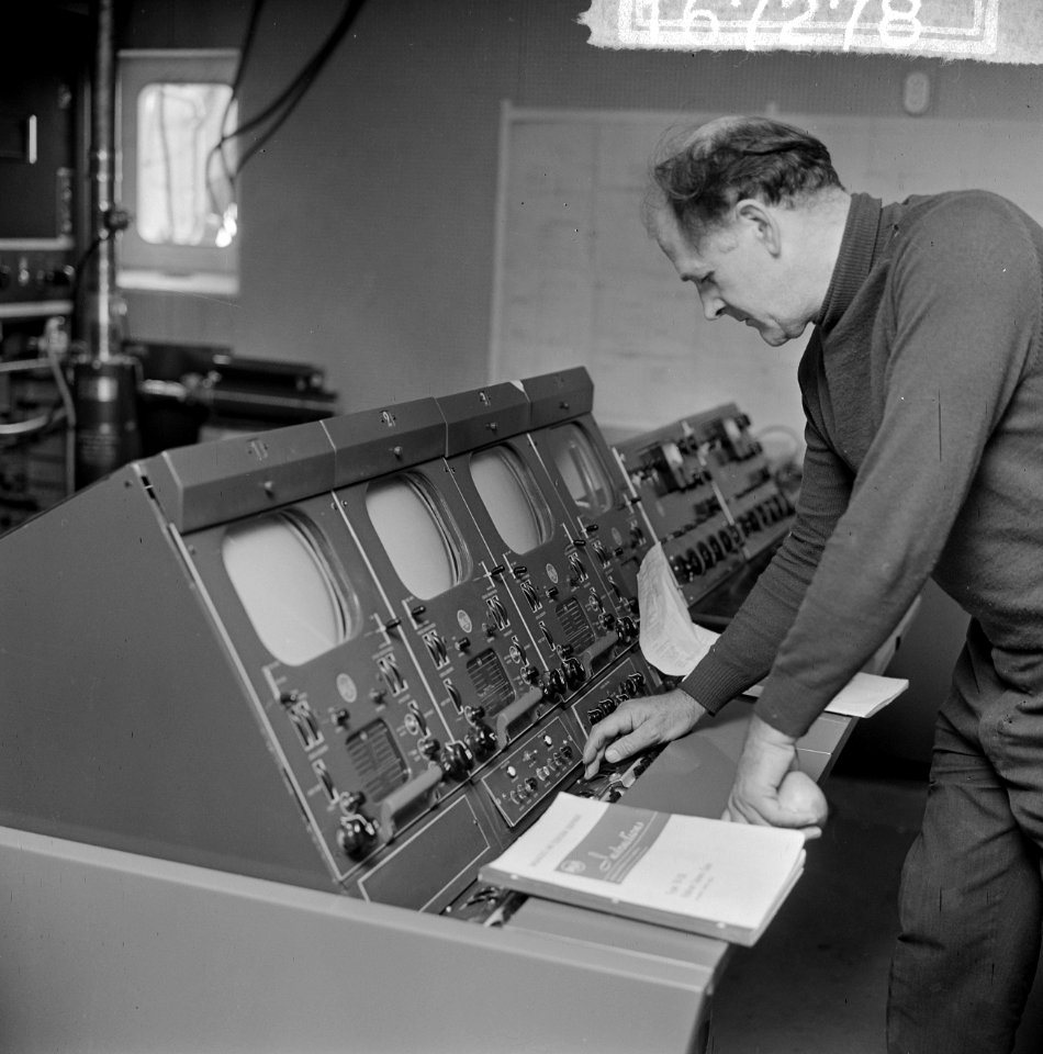 Het REM-eiland, technicus Maxwell Thompson bij een tv-monitor, Bestanddeelnr 916-7278