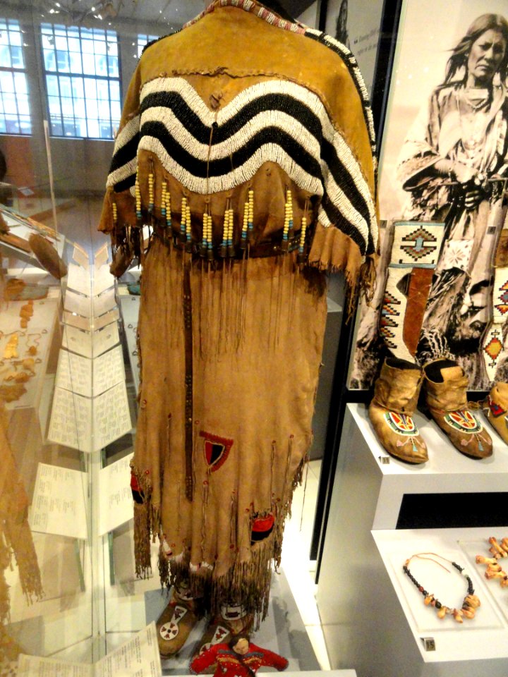 Hide dress with striped yoke dipping to frame deer tail, Blackfoot, Alberta or Montana, c. 1890 - Royal Ontario Museum - DSC00327