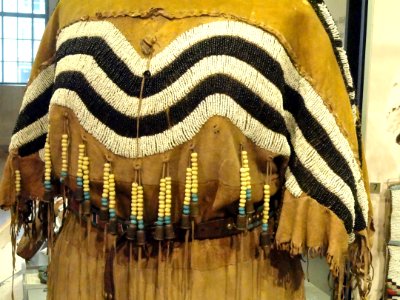 Hide dress with striped yoke dipping to frame deer tail (detail), Blackfoot, Alberta or Montana, c. 1890 - Royal Ontario Museum - DSC00329 photo