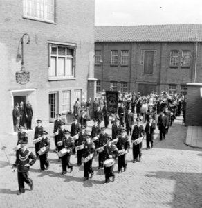 Harmonie Phileutonia marcherend, uiterst links met hoge hoed fabrieksdirecteur J, Bestanddeelnr 255-8539