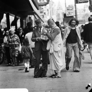 Hare Krishna aanhanger spreekt voorbijganger aan in Amsterdam, Bestanddeelnr 926-4273