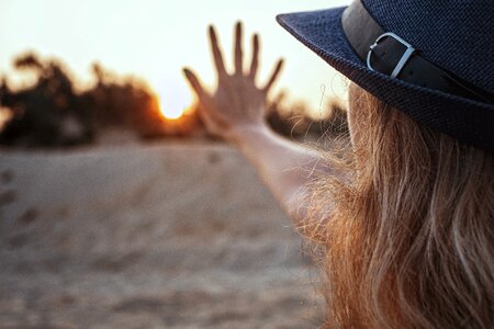 Sunset girl hand photo