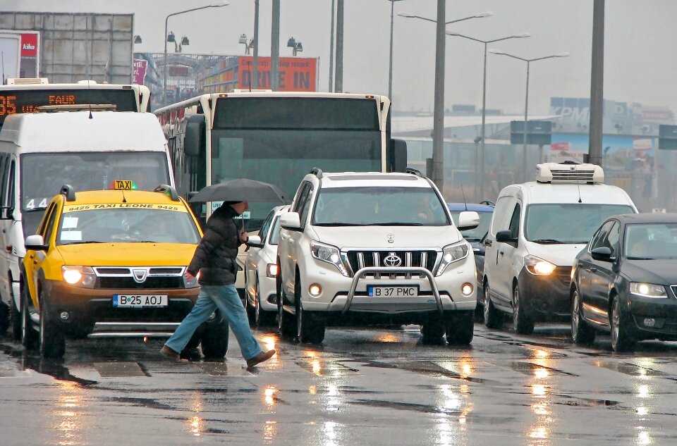 Passers wet road photo