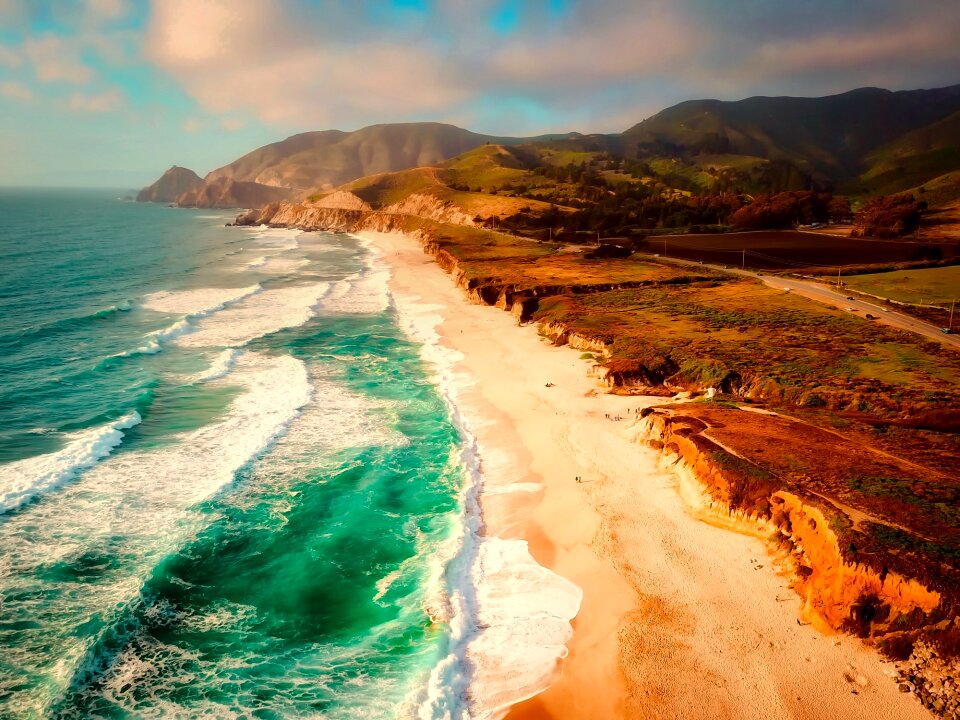 Waves coastline mountains