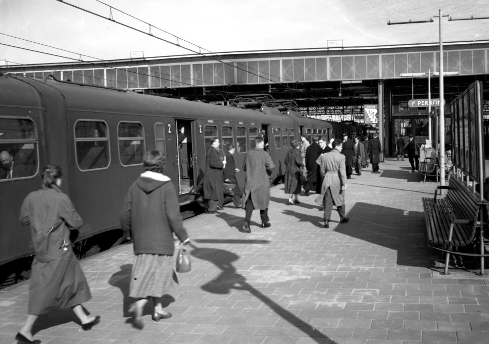 HUA-153166-Afbeelding van reizigers op het perron van het N.S.-station Leiden te Leiden. Langs het perron staat een electrisch treinstel mat. 1946
