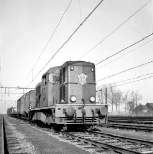 HUA-154302-Afbeelding van de diesel-electrische locomotief nr. 2482 (serie 2400-2500) van de N.S. met een goederentrein op het emplacement te Lage Zwaluwe