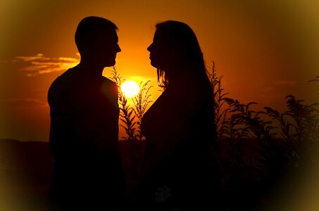 Sunset silhouettes kiss photo