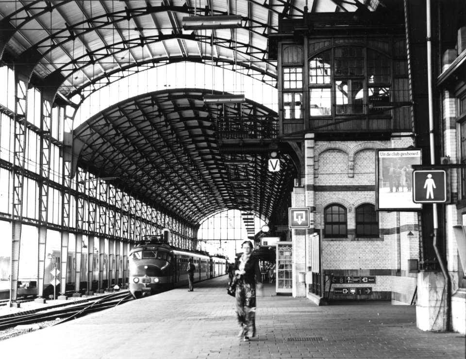 HUA-171414-Gezicht op het perron onder de perronkap van het N.S.-station Haarlem te Haarlem, met een trein bestaande uit electrische treinstellen mat. 1954 (Benelux) van de N.S