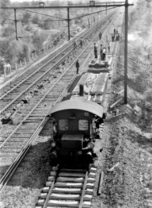 HUA-168949-Afbeelding van een werktrein met een locomotor (serie 200-300) van de N.S. tijdens het leggen van betonnen dwarsliggers op het proefbaanvak (3e spoor) te Bilthoven