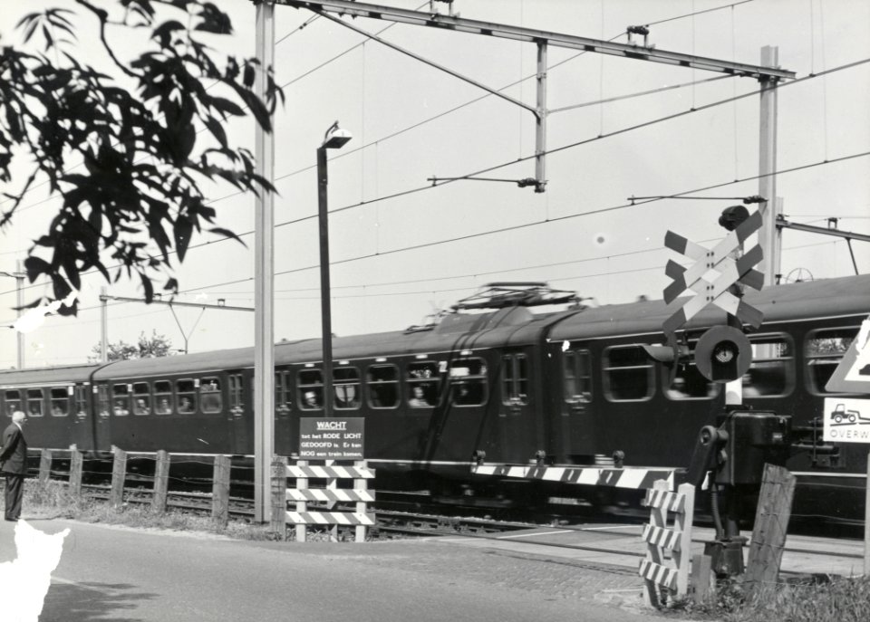 HUA-169420-Gezicht op de spoorwegovergang in de Voordorpsedijk te Blauwkapel (gemeente Utrecht), vanaf de Bastionweg, met een passerende trein